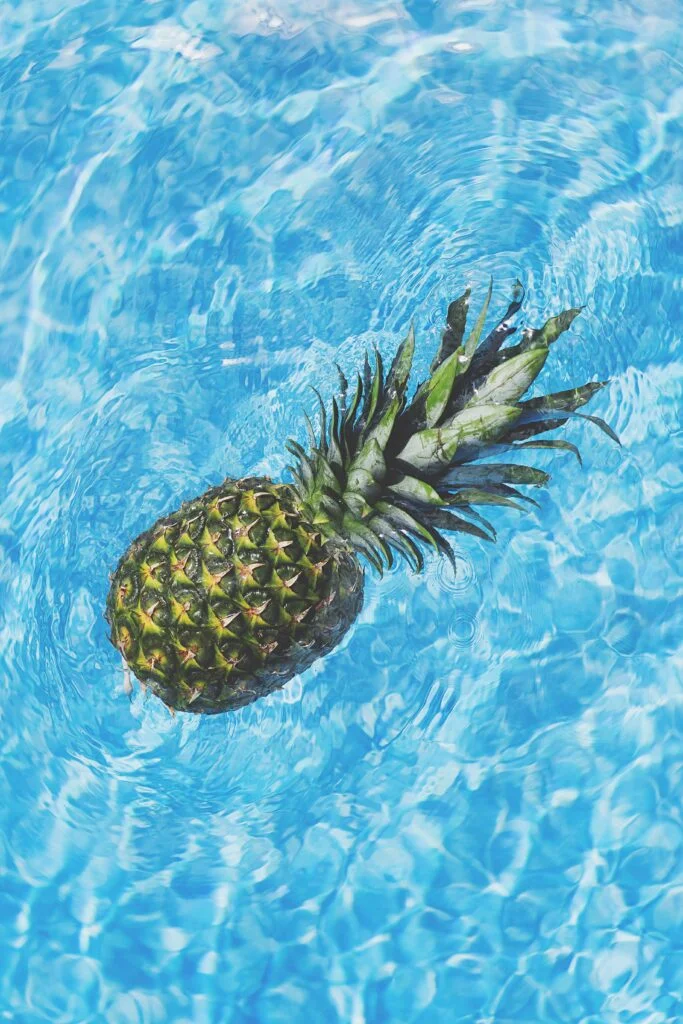 Pineapple Floating in Blue Water