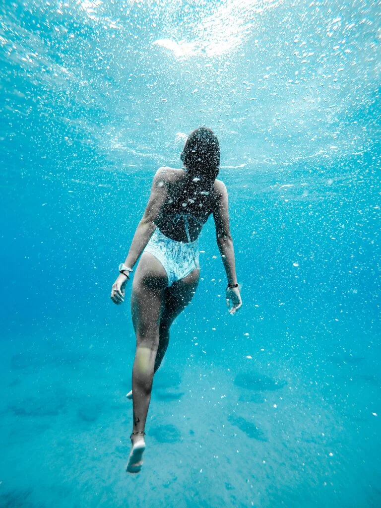 Women In A Swimsuit Swimming Underwater