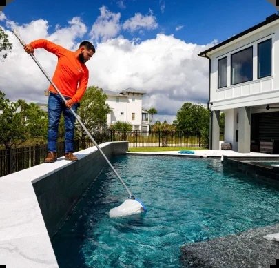 A Person Cleaning A Pool